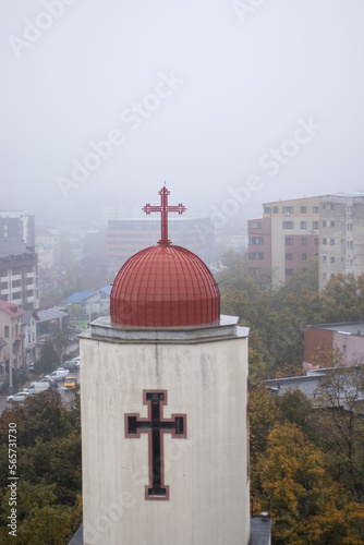 Canvas Print View over the town and catholic church, fog above the city, aerial view