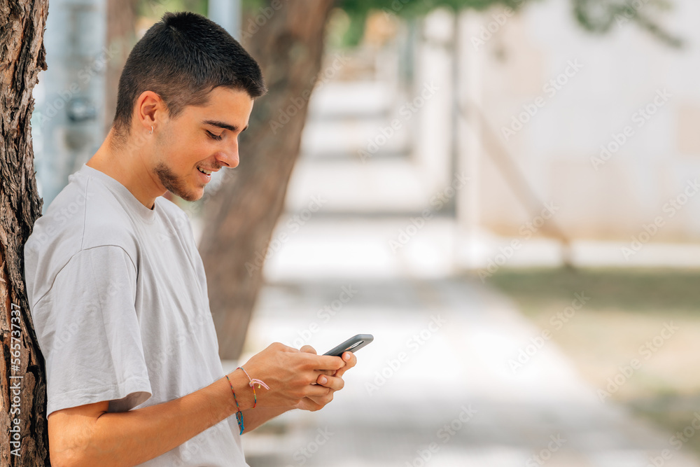 young teenager with mobile phone in the street young teenager with mobile phone in the street