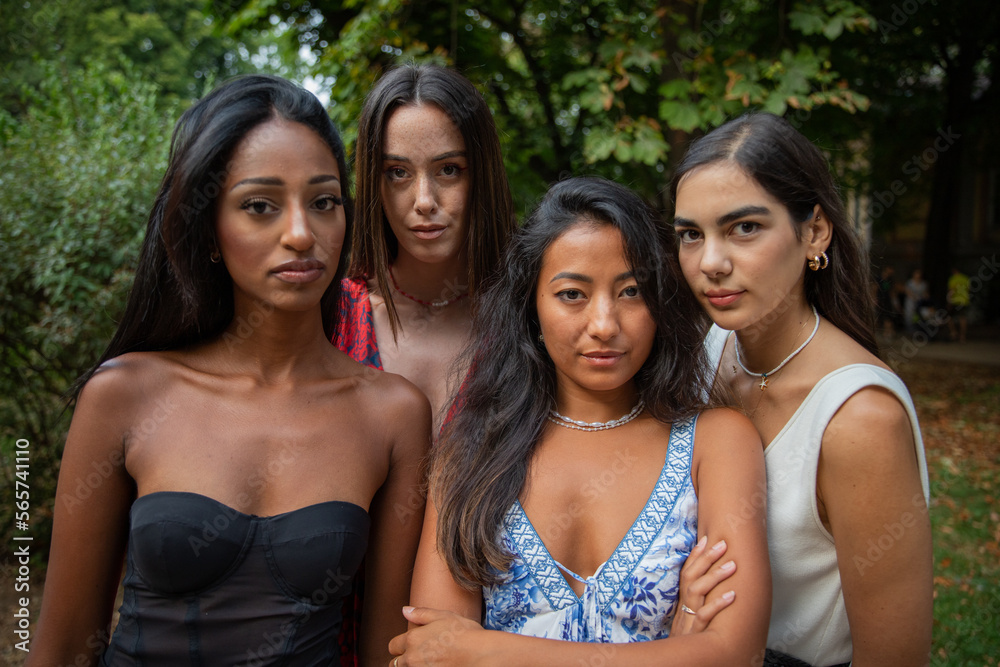 Four serious young women of different ethnicities together, concept of diversity and integration. Four serious young women of different ethnicities together, concept of diversity and integration.