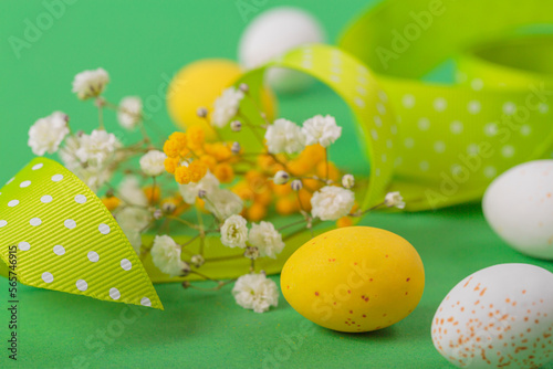 Canvas Print Minimalistic easter floral background made of chocolate candy eggs, flowers and