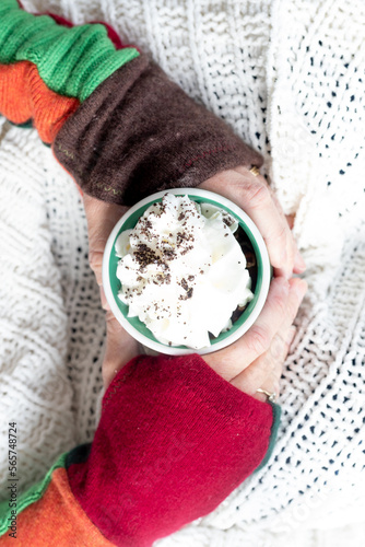  person holding a cup of hot chocolate cocoa with whipped cream