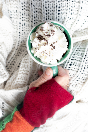 Mug of hot chocolate cocoa with whipped cream on a cold day