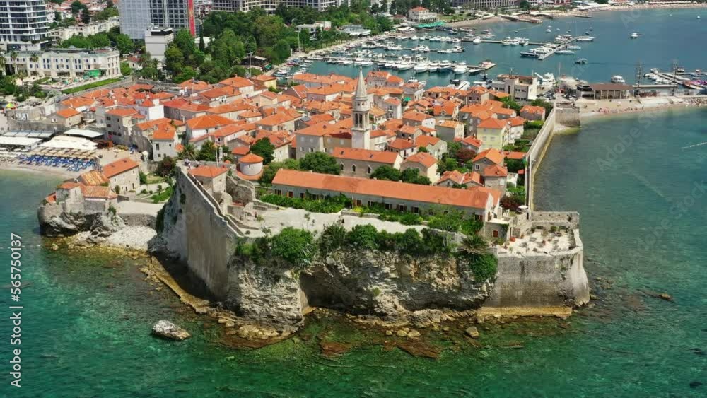 Aerial around view of walled old town of Budva city. Pier with moored yachts and boats. Adriatic sea, Montenegro, 4k Aerial around view of walled old town of Budva city. Pier with moored yachts and boats. Adriatic sea, Montenegro, 4k