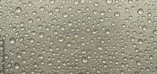 Round water drops on a silver horizontal background. Wet background for text.