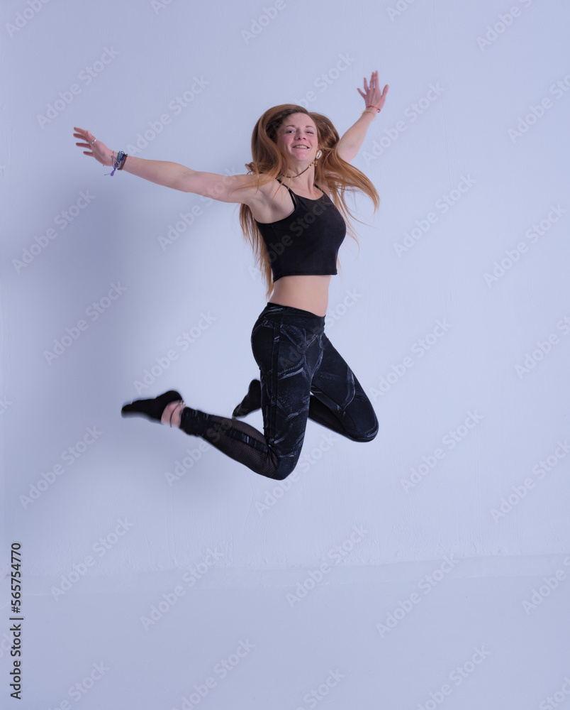 young woman with long hair jumping happy