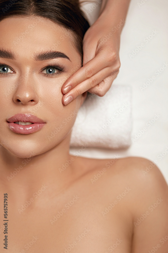 Face massage. Beautiful of young woman getting spa massage treatment at beauty spa salon.Spa skin and body care. Facial beauty treatment.Cosmetology. Face massage. Beautiful of young woman getting spa massage treatment at beauty spa salon.Spa skin and body care. Facial beauty treatment.Cosmetology.