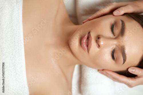 Face massage. Beautiful woman getting spa massage treatment at beauty spa salon.Spa skin and body care.