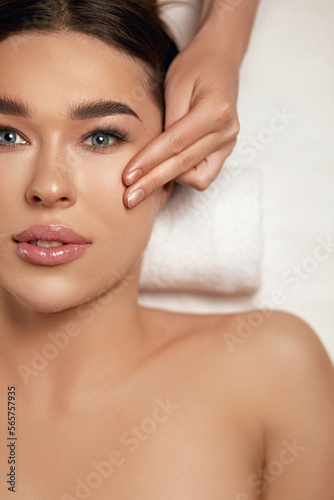 Face massage. Beautiful of young woman getting spa massage treatment at beauty spa salon.Spa skin and body care. Facial beauty treatment.Cosmetology.