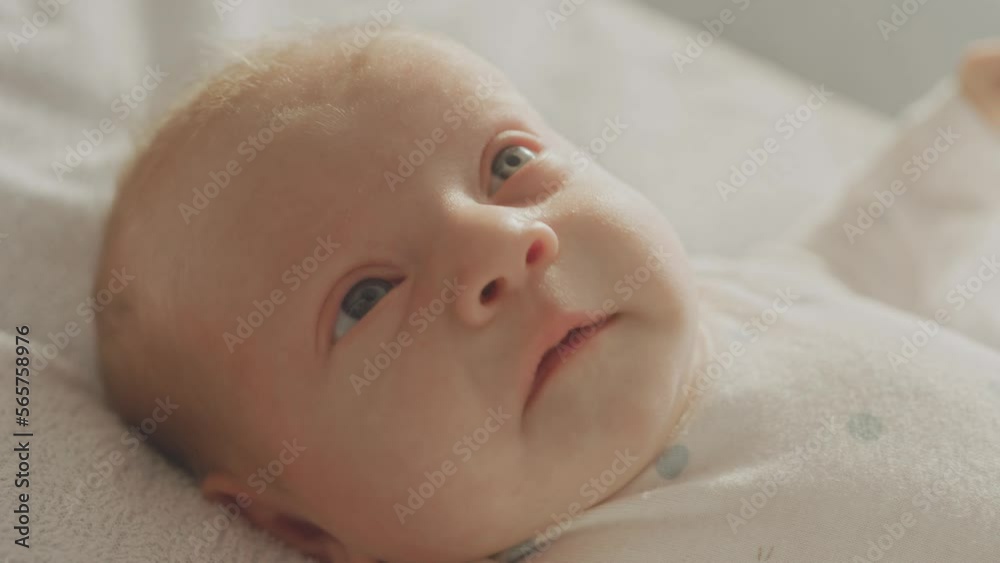 Cute Caucasian baby in her mummy's arms. Mother holding baby and smiling Cute Caucasian baby in her mummy's arms. Mother holding baby and smiling