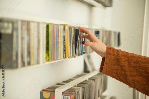 Close-up of a woman hand picking a cd from shelf, Munich, Bavaria, Germany