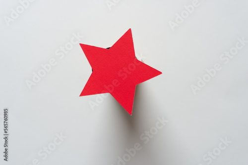 close up of a red paper star on a 3d object with shadow effect