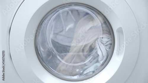 Washing clothes process. Washing machine working with laundry, close up