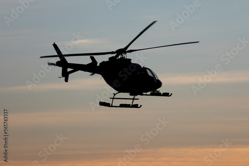 Helicopter silhouette in mid air at dusk