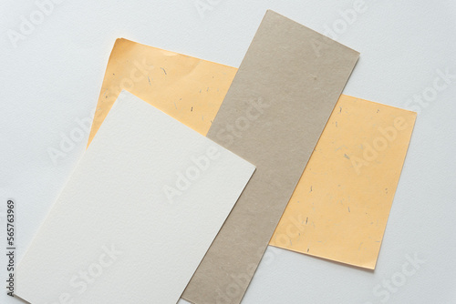white, beige, and yellow paper sheets on blank paper © eugen