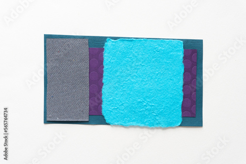 blue square with torn edges on various textured papers