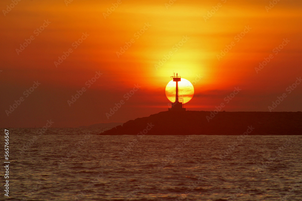 lighthouse with beautiful sunset and the ocean background