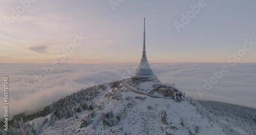 Jested tower mountain hill with snow mist and fog at golden hour