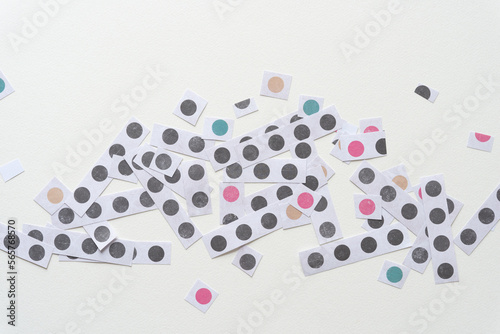 random group of short paper stripes with dots on blank paper