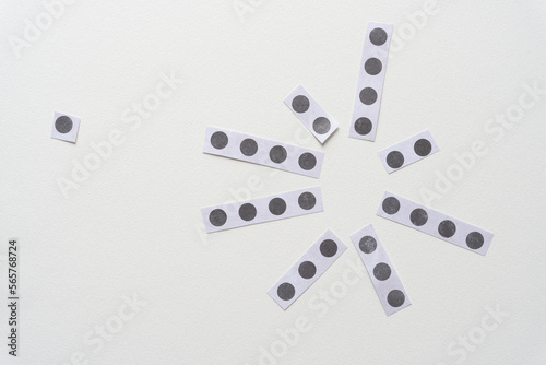 set of short paper stripes with dots on blank paper