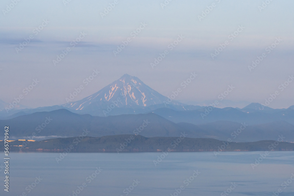 View of Avacha Bay and Vilyuchinsky Volcano (Vilyuchinskaya Sopka). Natural attractions of the Kamchatka Peninsula. Travel and tourism in Siberia and the Russian Far East. Beautiful natural background
