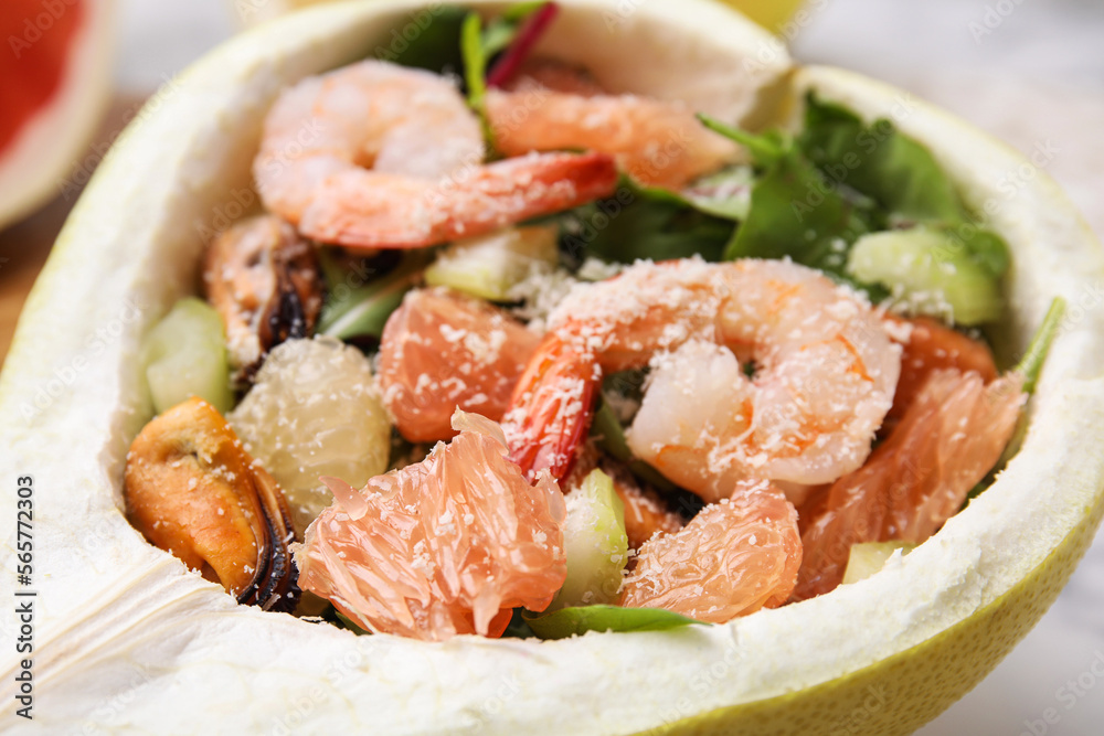 Delicious pomelo salad with shrimps in half of fruit, closeup Delicious pomelo salad with shrimps in half of fruit, closeup