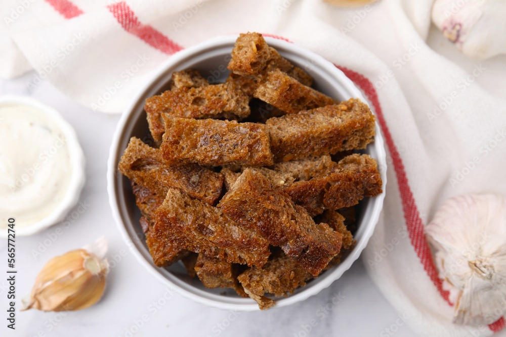 Crispy rusks with sauce on white marble table, flat lay Crispy rusks with sauce on white marble table, flat lay