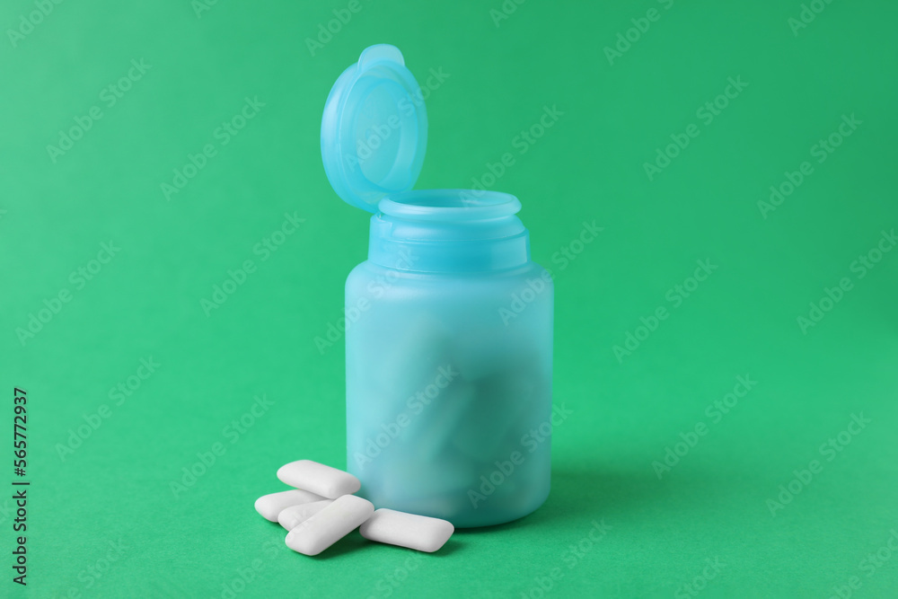 Jar with chewing gums on green background Jar with chewing gums on green background
