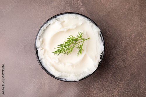 Delicious pork lard with dill in bowl on brown table, top view
