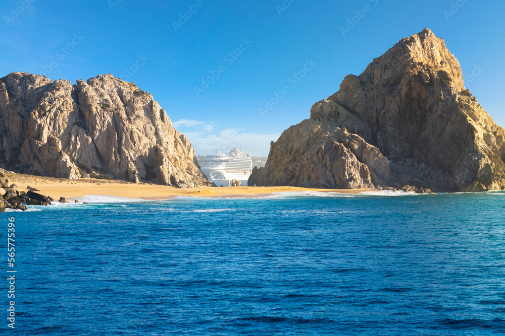 A cruise ship can be seen between two rocks above Lover’s Beach at the El Arco coastal formation at the resort city of Cabo San Lucas, Mexico. 