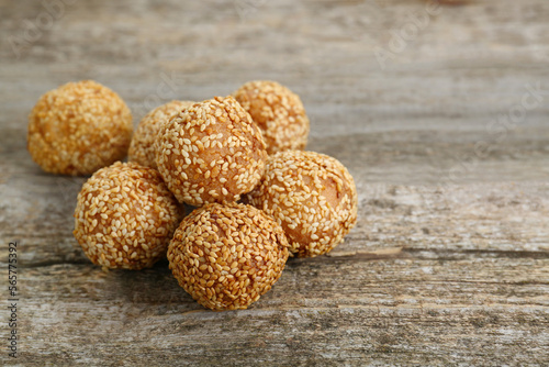 Delicious sesame balls on wooden table. Space for text