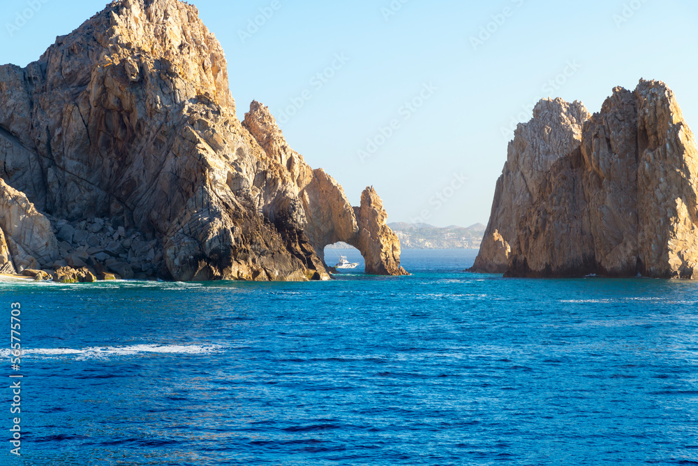 A small fishing boat can be seen through the famous El Arch, the Arch, at the Land's End region on the Baja Peninsula at Cabo San Lucas, Mexico.