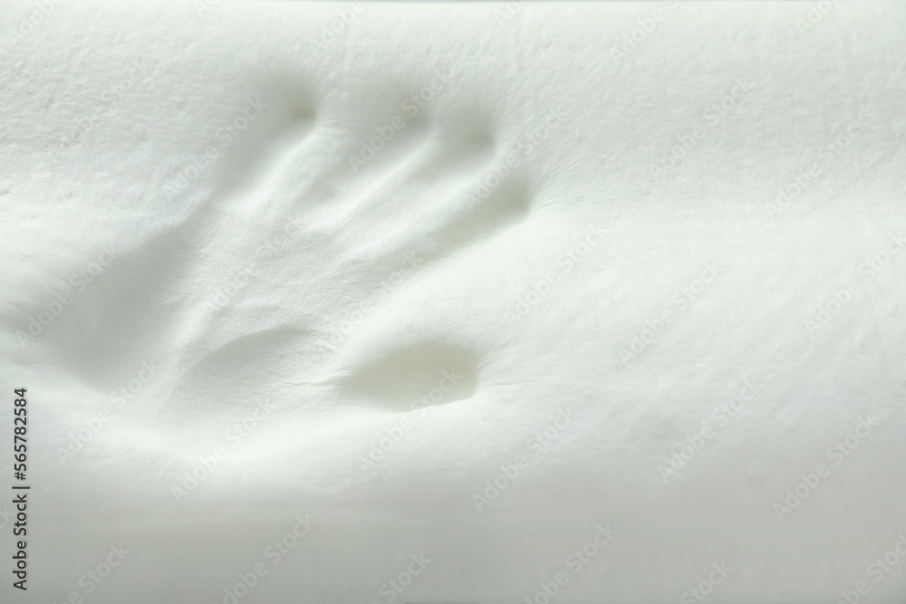 Fototapeta premium Handprint on white memory foam pillow, closeup