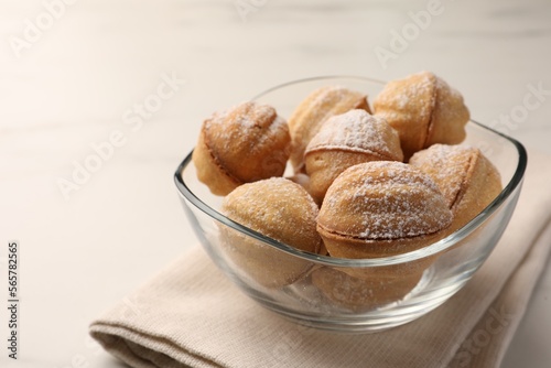 Homemade walnut shaped cookies with condensed milk on white marble table, closeup. Space for text