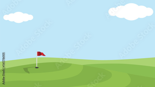 High and low bright green golf course. Holes and flags on the hill. Under blue sky and white clouds.