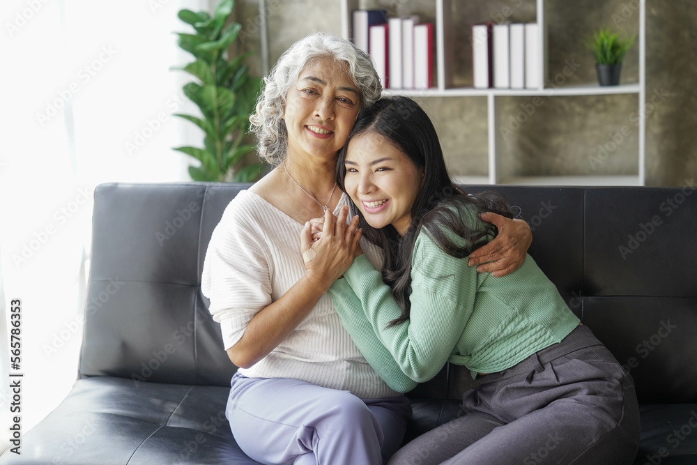 © Tj - Candid attractive beautiful mum sit at cozy sofa couch living room in family moment grown child kid celebrate joy good warm time kiss relationship with retired overjoy lady girl health life.
