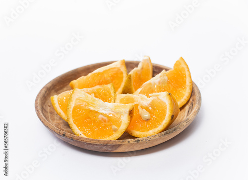  orange slices in a bowl on a white background. The photo is out of focus, blurred, and noisy.