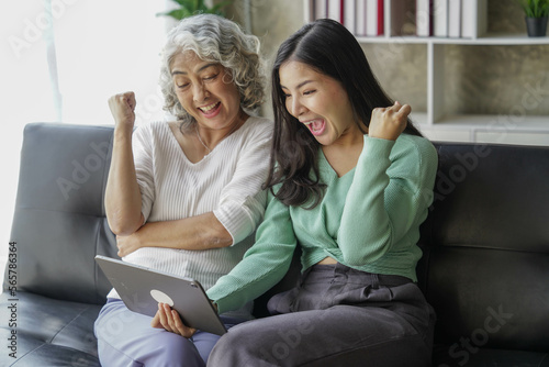 Candid attractive beautiful mum sit at cozy sofa couch living room in family moment grown child kid celebrate joy good warm time kiss relationship with retired overjoy lady girl health life.