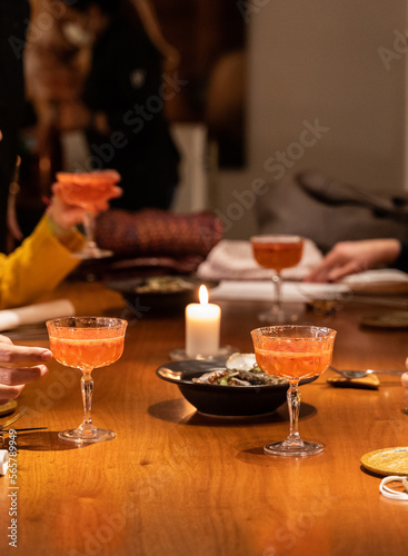 hands holding cocktail glasses on a restaurant table