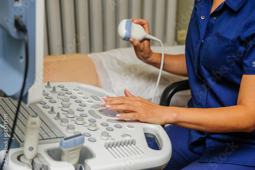 Medical specialists near ultrasound machine in the hospital ward