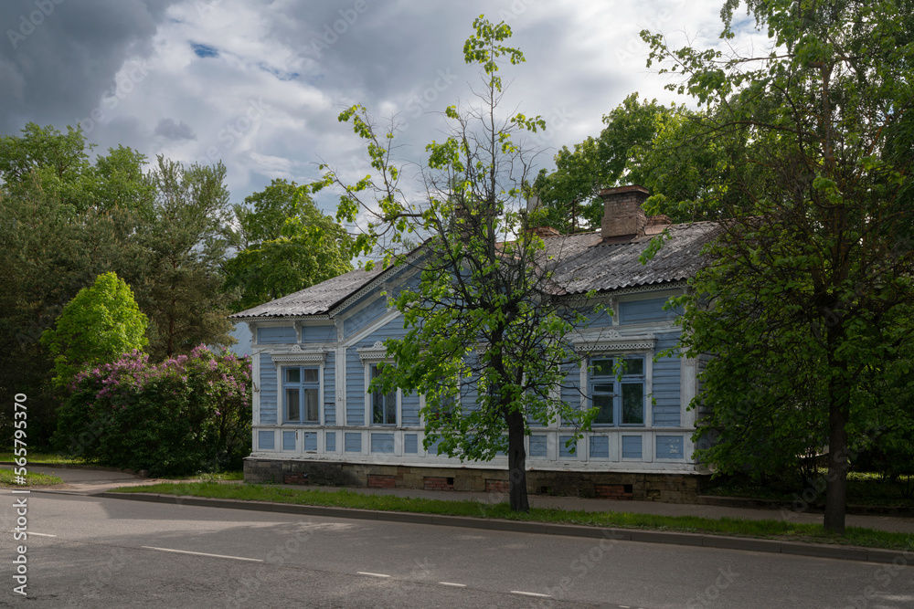 An old wooden traditional Russian residential building, an architectural monument, on the street of Gatchina on a summer day, Leningrad region, Russia