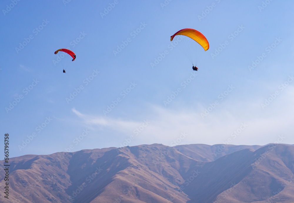 Active sport, paraglider and people in the sky. Instructor and passenger on a paraglider. Active sport, paraglider and people in the sky. Instructor and passenger on a paraglider.