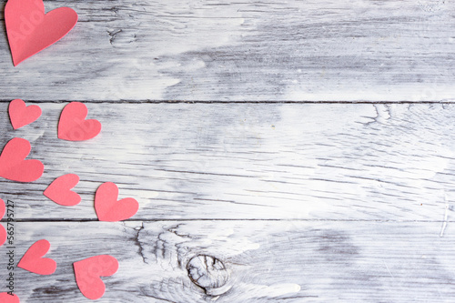 White painted wooden background with hearts carved on it. Background for Valentine's Day