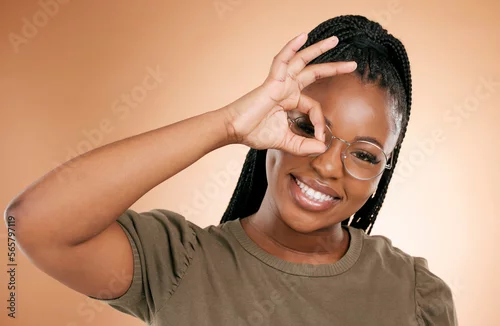 Obraz Black woman, portrait smile and ok hand sign fro perfect, great or right against studio background. Happy African American female smiling in happiness showing okay emoji gesture for positive attitude
