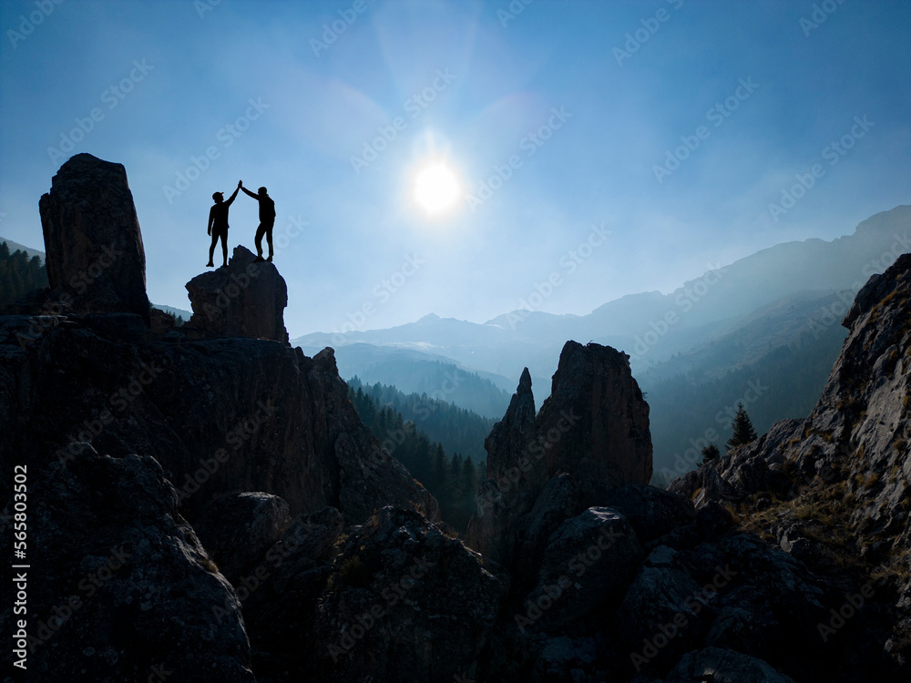 activity of successful couples together and mystical landscapes of enormous mountains
