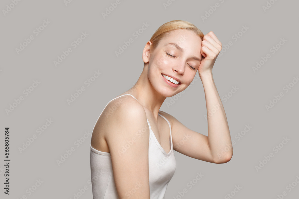 Blonde woman smiling isolated on grey background. Beauty, cosmetics, skincare Blonde woman smiling isolated on grey background. Beauty, cosmetics, skincare