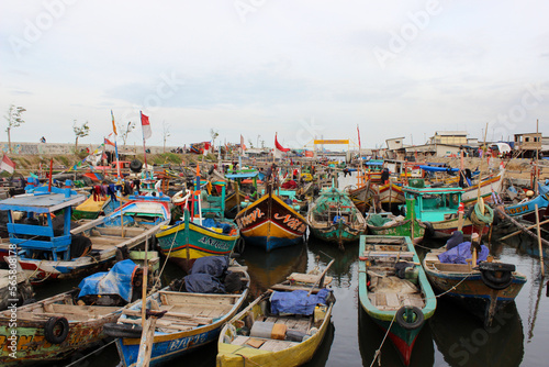 Traditional fishing boats are parked on the edge of the fishing village