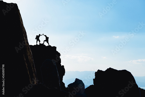 silhouette of professional climbers on the cliffs of the peak mountains