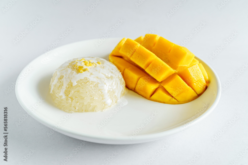 Fresh ripe mango and sticky rice with coconut milk. Traditional Thai dessert on white background.