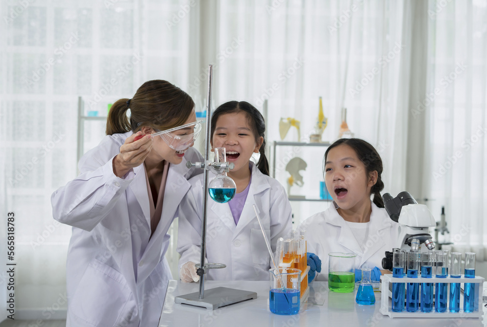 children having fun doing chemistry experiments in the science classroom that chemical laboratory staff as a mentor teaching kids test the liquid in a flask children having fun doing chemistry experiments in the science classroom that chemical laboratory staff as a mentor teaching kids test the liquid in a flask