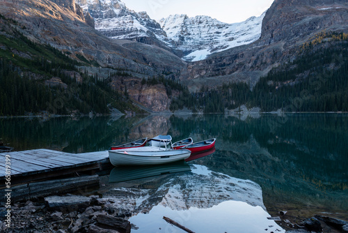 Mountains and boats reflected in the clear waters of Lake O'Hara, Yoho National Park, Canadian Rockies.